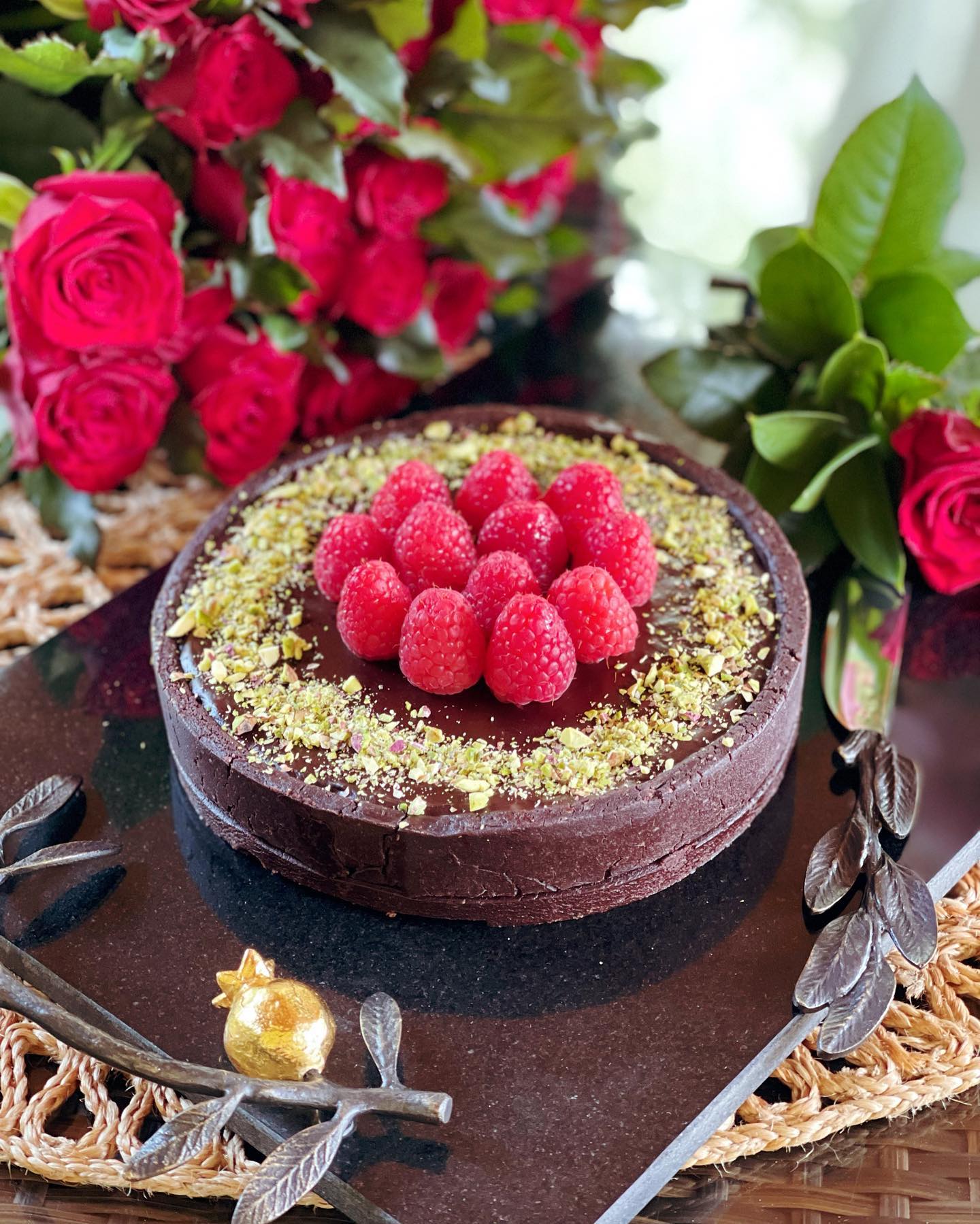 Chocolate tart with raspberry puree & pistachios