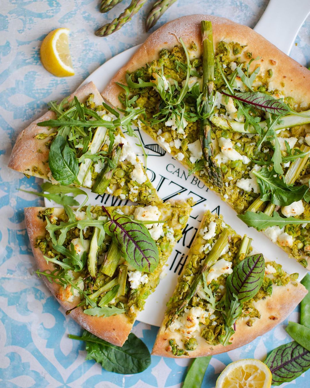 Spring pizza with green peas, goat cheese and herbs