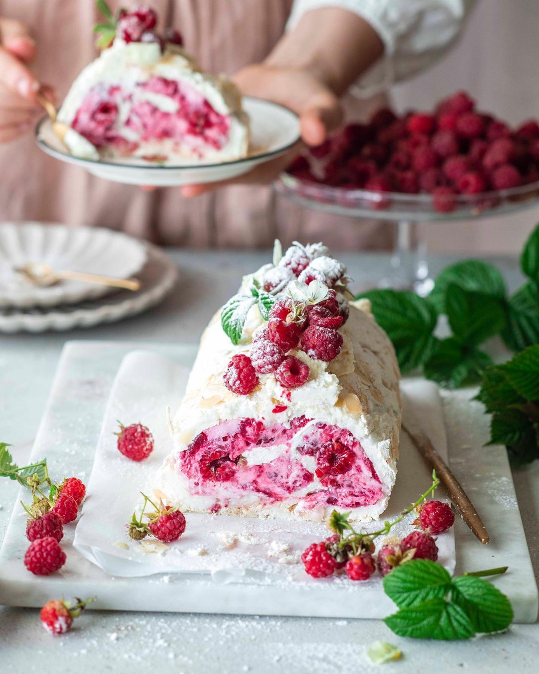 Meringue roll with raspberry jam and fresh raspberries